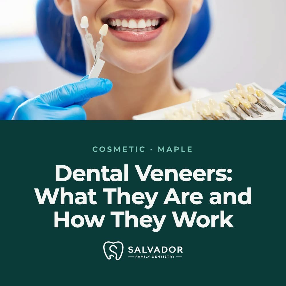 woman smiling while dentist showing a sample veneers